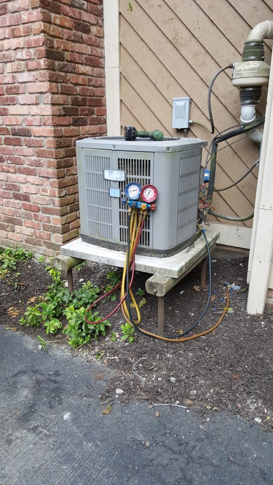 Outdoor heat pump with service gauges attached during an Indy North service visit